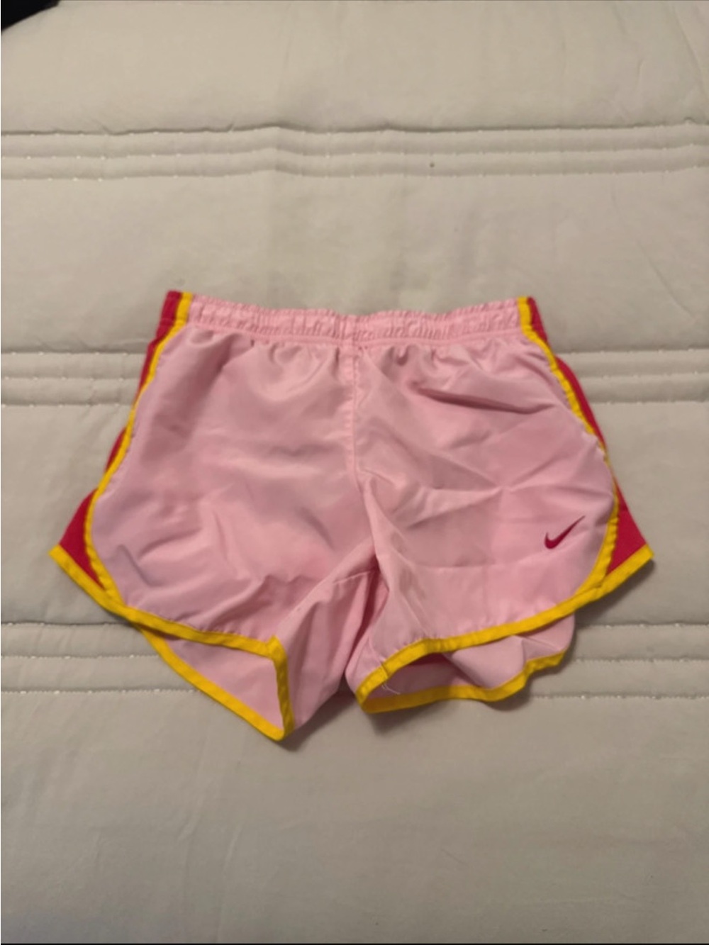 Nike Pink Shorts with Yellow Trim and Red Accents
